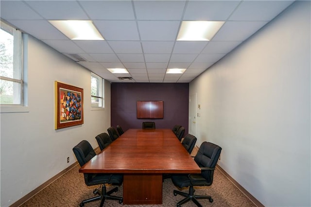 carpeted home office featuring a drop ceiling