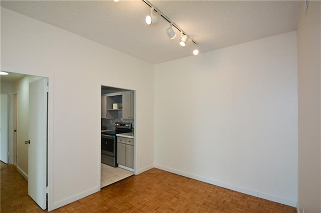 empty room featuring a textured ceiling and light parquet floors