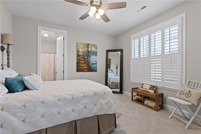 carpeted bedroom with a ceiling fan, baseboards, and visible vents