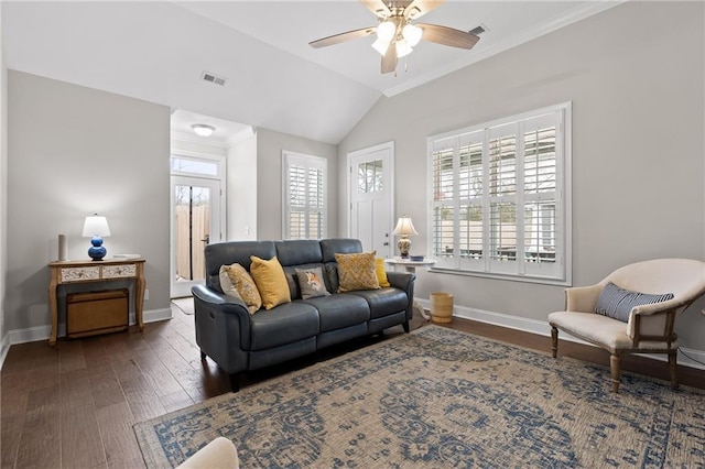 living area featuring vaulted ceiling, visible vents, baseboards, and wood finished floors