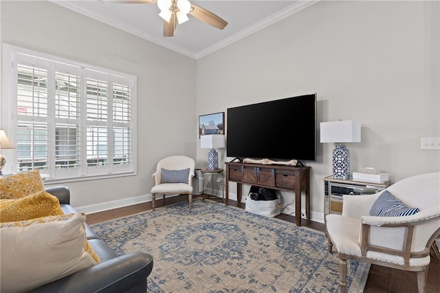 living room featuring crown molding, wood finished floors, baseboards, and ceiling fan