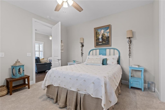 bedroom featuring baseboards, light colored carpet, and ceiling fan