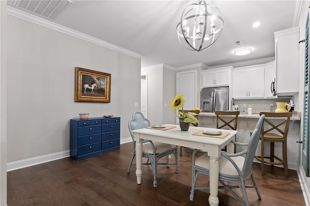 dining area with visible vents, crown molding, baseboards, dark wood finished floors, and an inviting chandelier