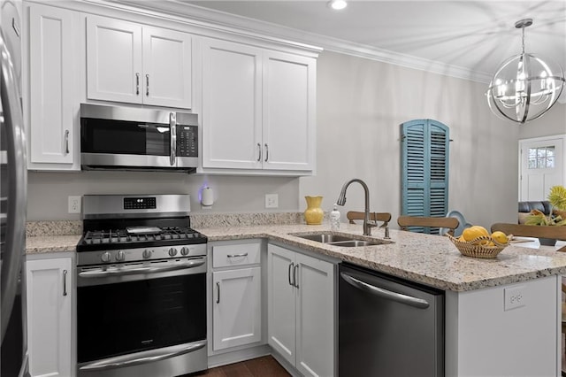 kitchen with ornamental molding, a peninsula, stainless steel appliances, white cabinetry, and a sink