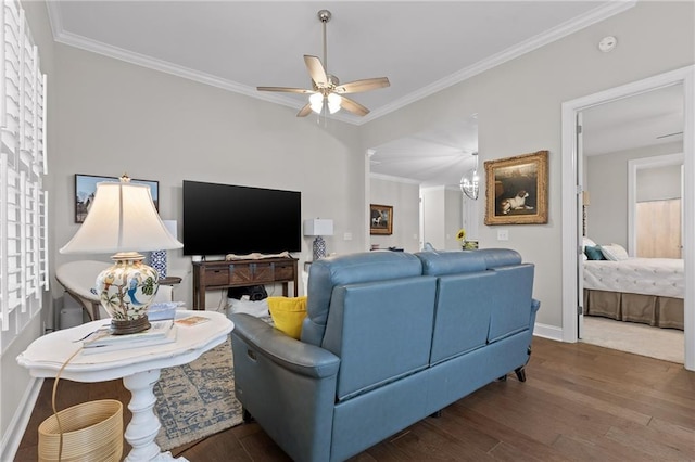 living room featuring a ceiling fan, crown molding, wood finished floors, and baseboards