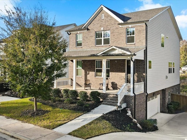 view of front of property with a porch and a garage