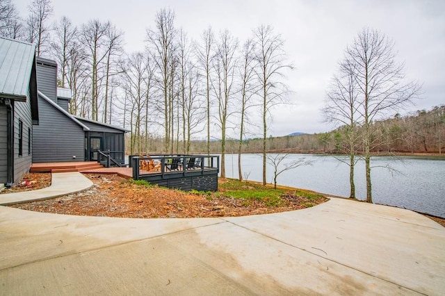 exterior space with a deck with water view