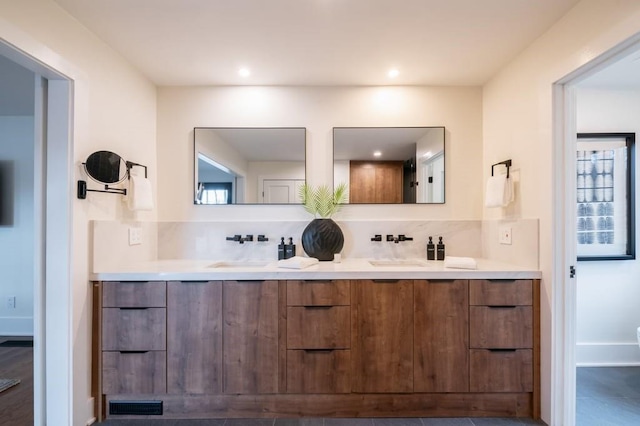 bathroom with tasteful backsplash and vanity