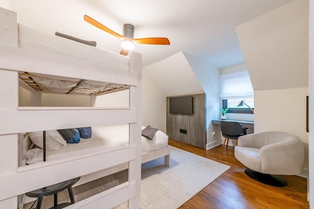 interior space with ceiling fan, dark hardwood / wood-style floors, and vaulted ceiling