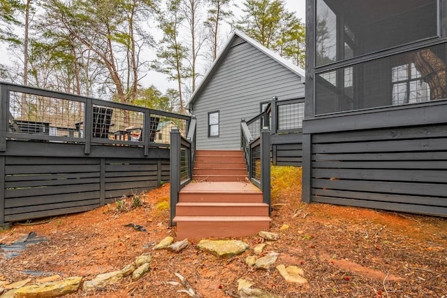 back of property featuring a wooden deck