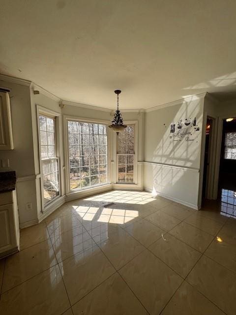 unfurnished dining area featuring tile patterned floors and crown molding