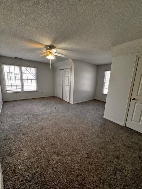 unfurnished bedroom featuring a closet, baseboards, and carpet