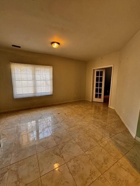 empty room with visible vents and baseboards