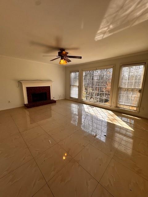 unfurnished living room with baseboards, ceiling fan, and a fireplace