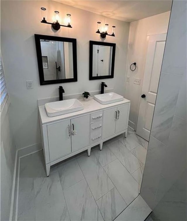 2022 Detroit Ave, Atlanta, GA 30314 - bathroom with baseboards, marble finish floor, a sink, and double vanity