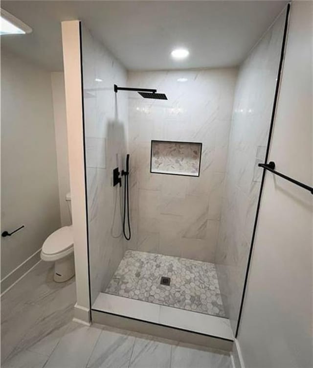 2022 Detroit Ave, Atlanta, GA 30314 - bathroom with baseboards, marble finish floor, toilet, and tiled shower