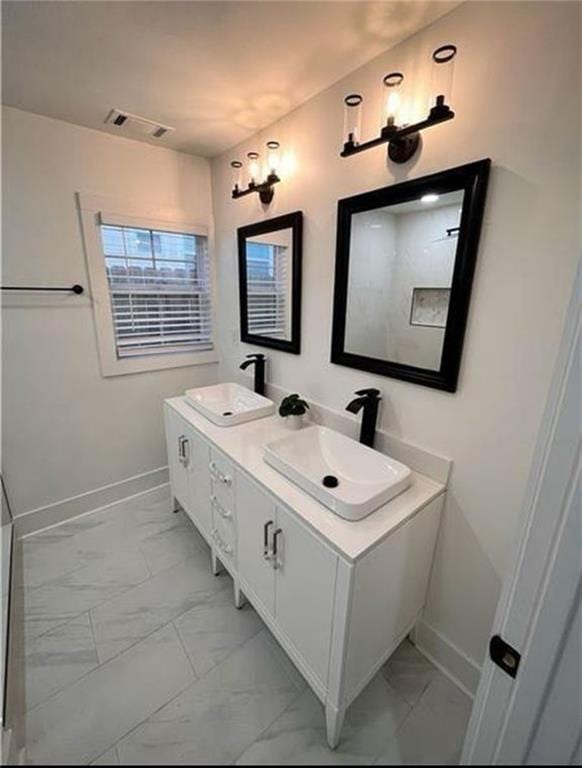 2022 Detroit Ave, Atlanta, GA 30314 - bathroom featuring marble finish floor, baseboards, double vanity, and a sink