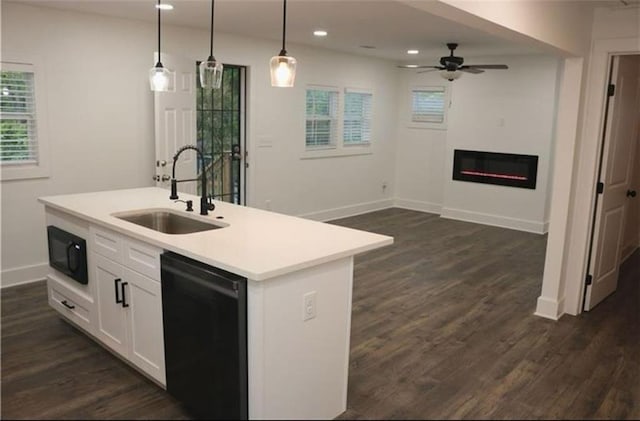 2022 Detroit Ave, Atlanta, GA 30314 - kitchen with light countertops, a sink, a ceiling fan, dishwasher, and a glass covered fireplace