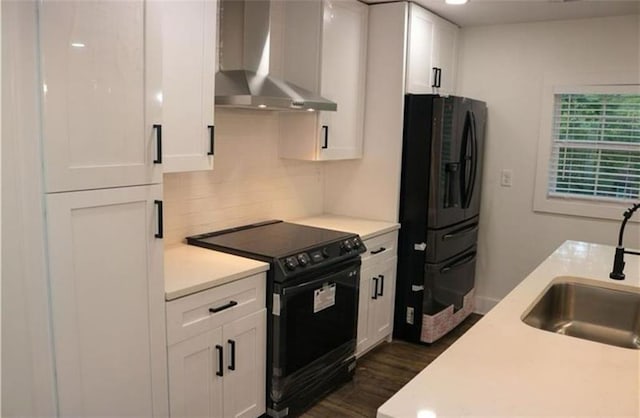 2022 Detroit Ave, Atlanta, GA 30314 - kitchen with light countertops, a sink, white cabinetry, wall chimney range hood, and black appliances
