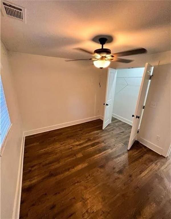 2022 Detroit Ave, Atlanta, GA 30314 - unfurnished bedroom with baseboards, dark wood-style flooring, a textured ceiling, and visible vents