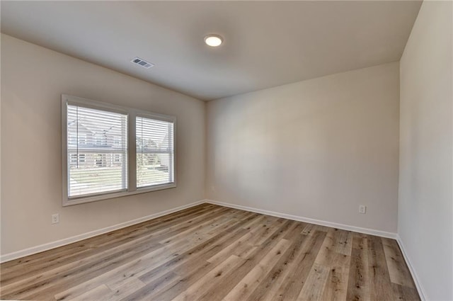 empty room with light hardwood / wood-style floors