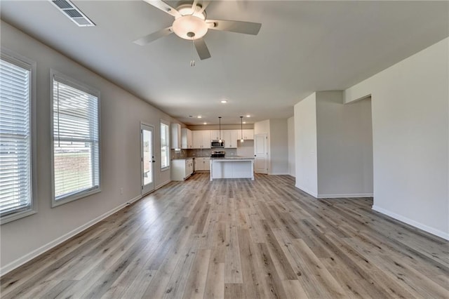 unfurnished living room featuring light hardwood / wood-style floors and ceiling fan