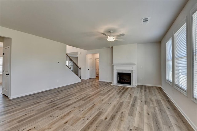 unfurnished living room featuring light hardwood / wood-style floors and ceiling fan