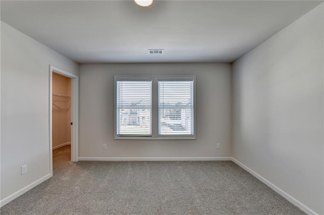 unfurnished room featuring light colored carpet