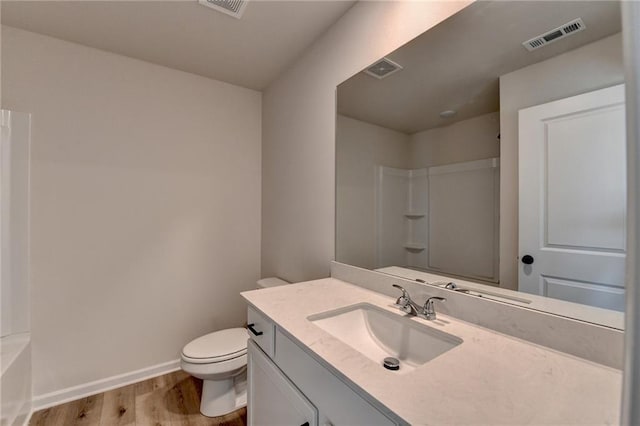 bathroom featuring hardwood / wood-style flooring, vanity, and toilet