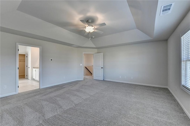 interior space featuring ceiling fan and a tray ceiling