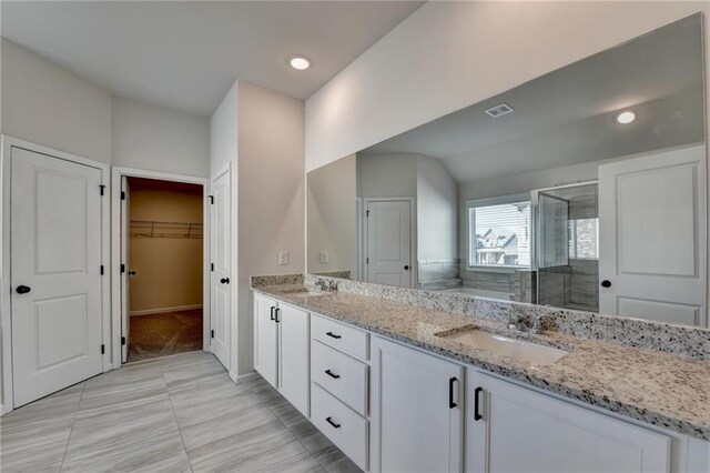 bathroom with tile patterned flooring, vanity, and an enclosed shower