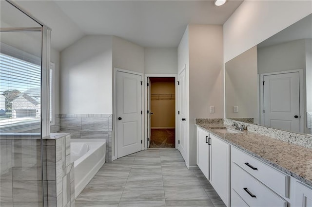 bathroom with vanity, plus walk in shower, and vaulted ceiling