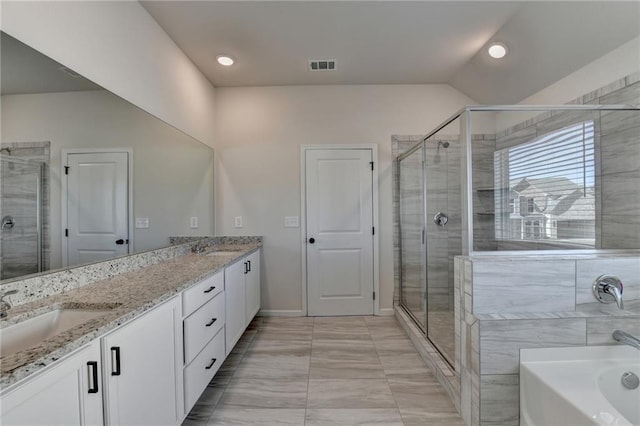 bathroom featuring plus walk in shower, vanity, and vaulted ceiling