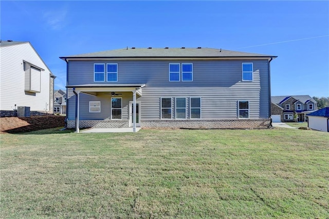 rear view of house featuring a yard, ceiling fan, and cooling unit