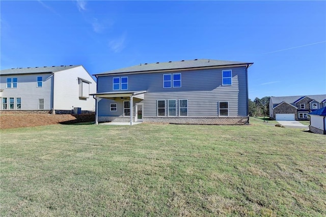 rear view of property featuring a lawn and a patio area