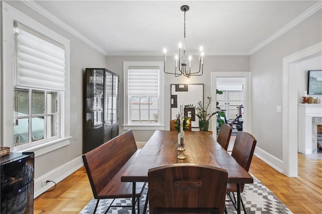 dining space featuring light parquet flooring, ornamental molding, and a chandelier