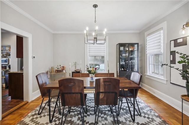 dining room with an inviting chandelier, crown molding, and a healthy amount of sunlight