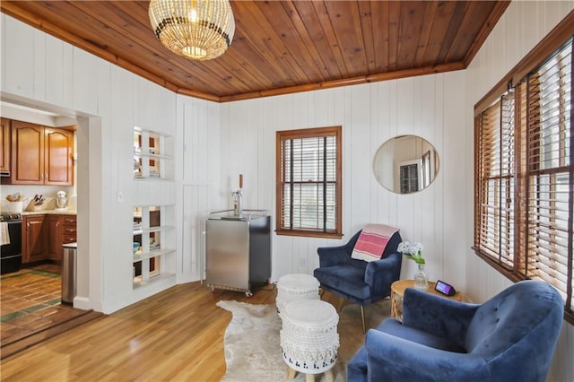 living area with light tile floors, wood ceiling, and an inviting chandelier