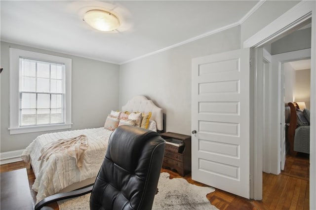 bedroom with dark parquet flooring and crown molding