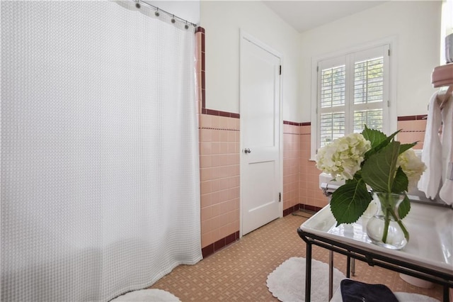 interior space featuring light tile floors and tile walls