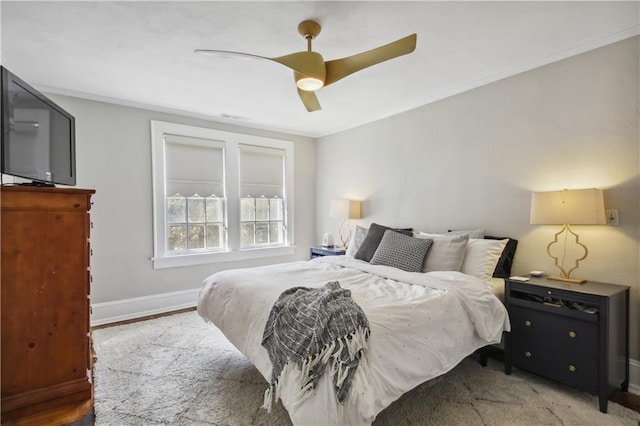 bedroom with ceiling fan, crown molding, and light hardwood / wood-style flooring