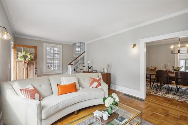 living room with light parquet floors, ornamental molding, and a notable chandelier