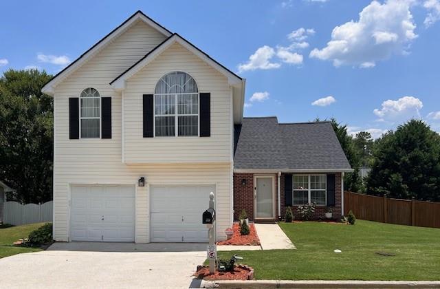 view of front property featuring a front lawn and a garage