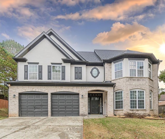 view of front of house with a yard and a garage