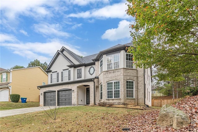 view of front of house featuring concrete driveway, an attached garage, fence, a front lawn, and brick siding