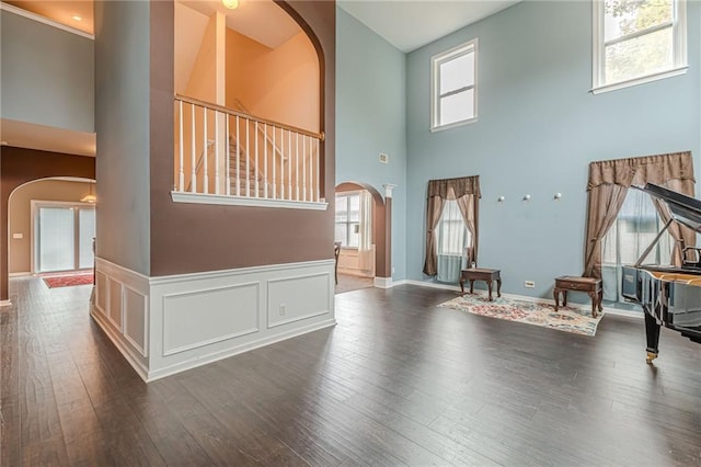 living room featuring a wealth of natural light and dark hardwood / wood-style floors