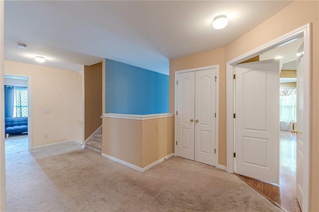 hallway with light colored carpet