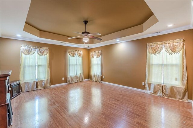 unfurnished room featuring ceiling fan, crown molding, and a raised ceiling