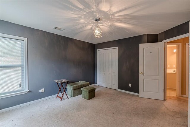 unfurnished office featuring built in desk and light colored carpet