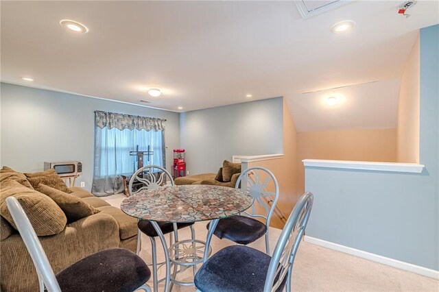 dining area featuring light carpet